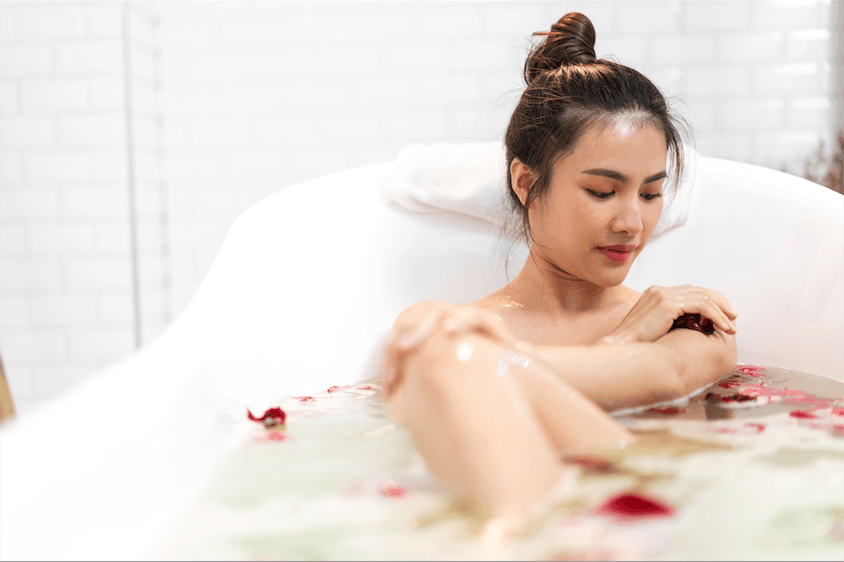 Asian woman taking a warm bubble bath