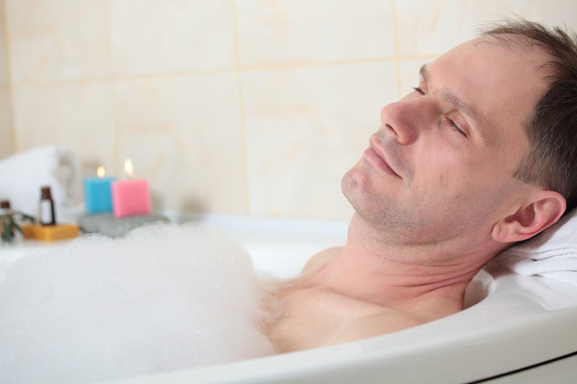 Adult man having a bath with essential oil