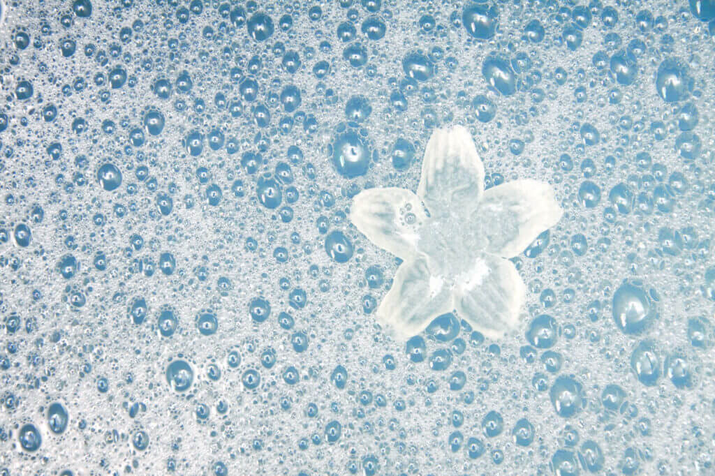 Bubbles and white flower in bubble bath