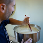 Javier Folgar stirring the ingredients to make bubble bath Photo by Nick Kraimer