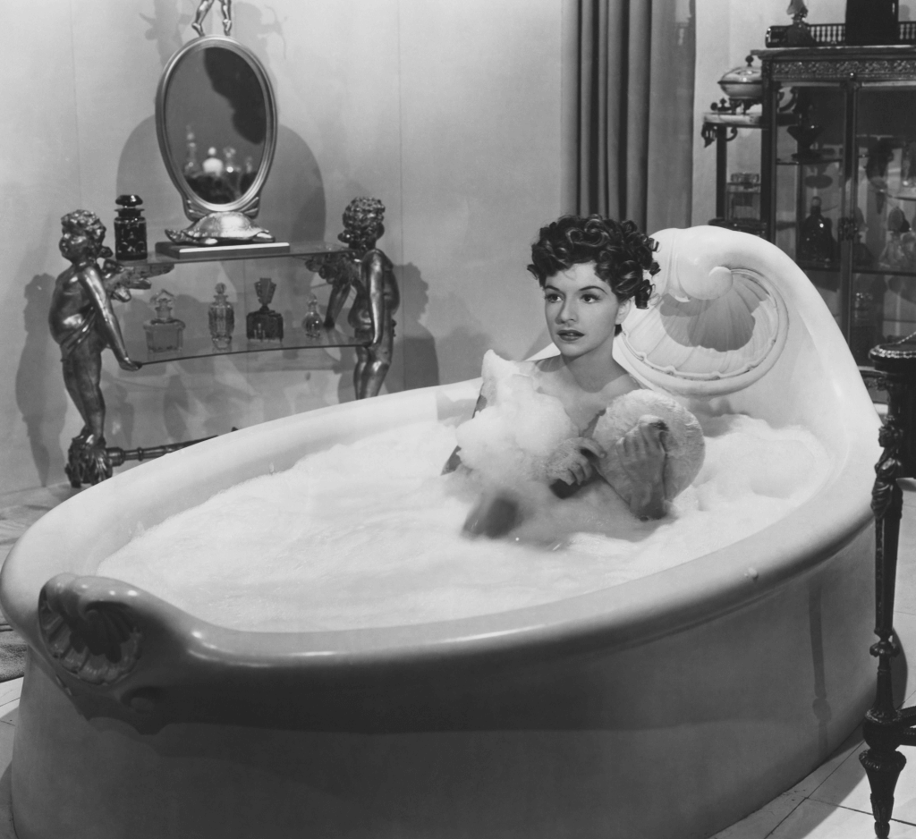 Old Fashion bubble bath tub with woman taking a bubble bath