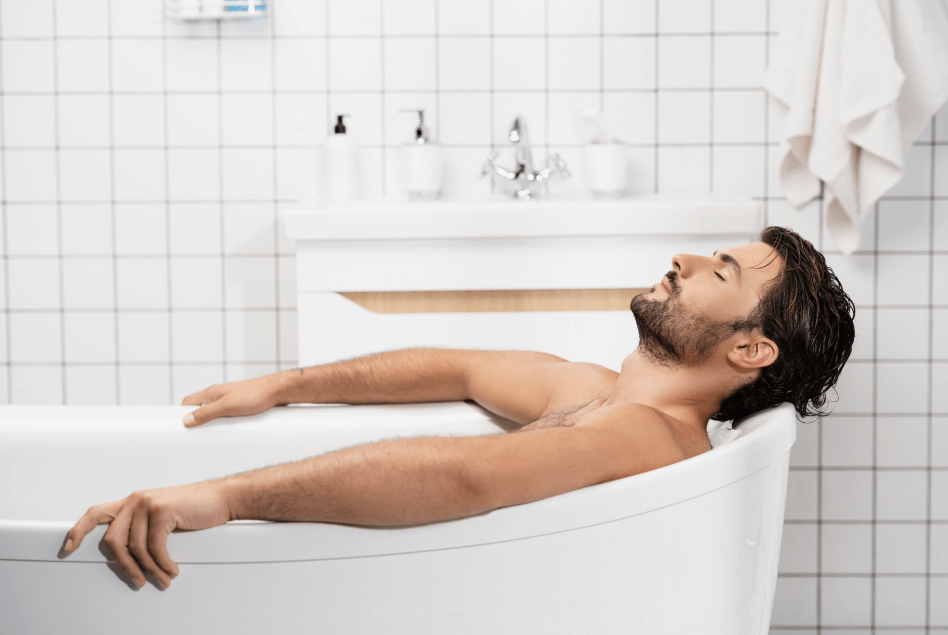 Man taking a soothing bubble bath.